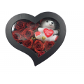 Artificial roses with gliter in a heart-shaped box